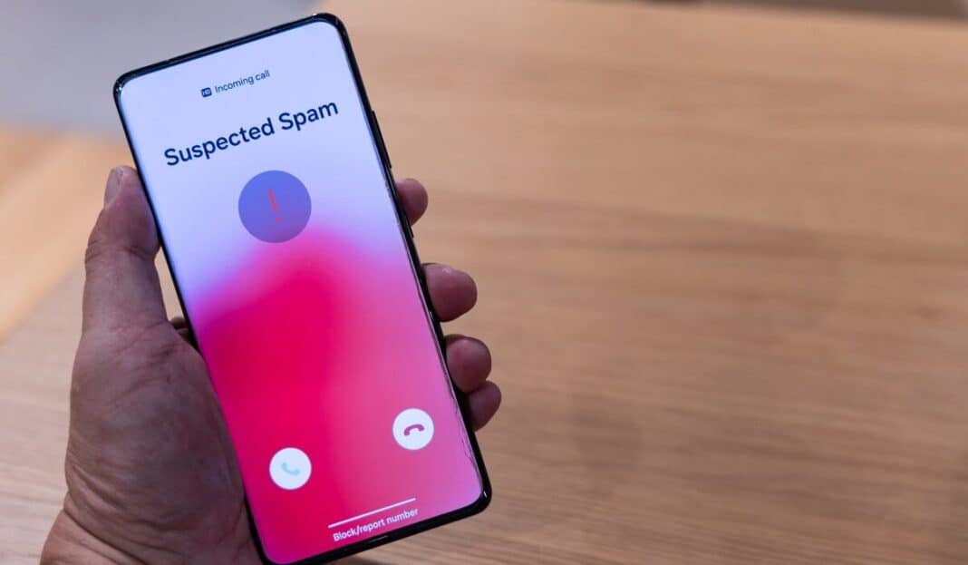 Hand,Holding,Smart,Phone,With,Suspected,Spam,Incoming,Call,Warning.